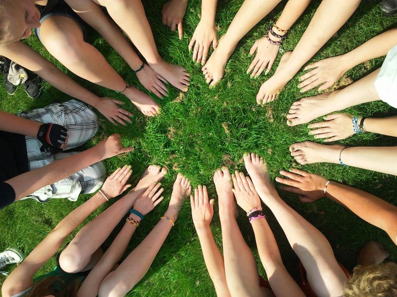 Image of arms reaching out to connect in a circle.